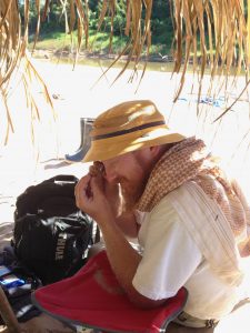 Erik Seiffert inspecting a tiny fossil at the Santa Rosa site in Amazonian Perú.